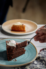 Plate with slice of tasty homemade chocolate cake on table