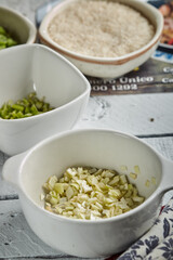 Bowl of chopped onion on wood background
