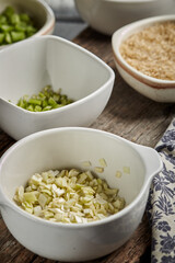 Bowl of chopped onion on wood background