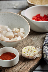 Fish raw for paella on the dark wood table