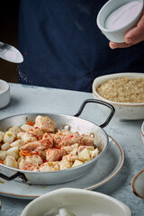 Cooking and making a traditional Spanish Paella. Traditional way of preparing Valencian paella