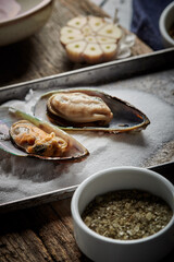 Mussels in wine with parsley and garlic. Seafood. Clams in the shells. Delicious snack for gourmands. Selective focus