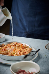 Cooking and making a traditional Spanish Paella. Traditional way of preparing Valencian paella