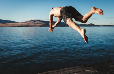 person diving into a lake