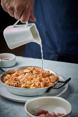 Cooking and making a traditional Spanish Paella. Traditional way of preparing Valencian paella