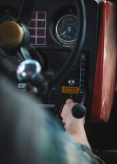 hand starting up a tractor