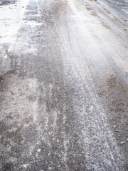 slippery ice-covered city road after freezing rain on cold autumn day