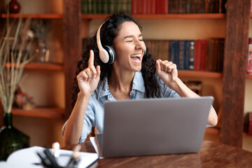 Woman listening to music online in headphones