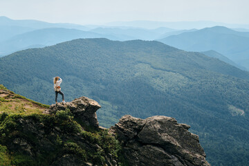 Girl enjoy scenics view on valley. Beautiful nature landscape in mountains. Hiking journey on tourist trail. Outdoor adventure. Travel and exploration. Healthy lifestyle, leisure activities