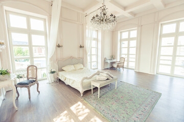 beautiful white bright clean interior bedroom in luxurious baroque style.