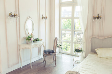 beautiful white bright clean interior bedroom in luxurious baroque style.