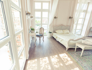 beautiful white bright clean interior bedroom in luxurious baroque style.
