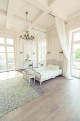 beautiful white bright clean interior bedroom in luxurious baroque style.