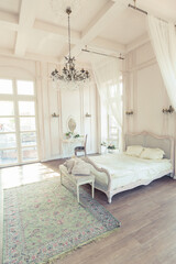 Fototapeta na wymiar beautiful white bright clean interior bedroom in luxurious baroque style.