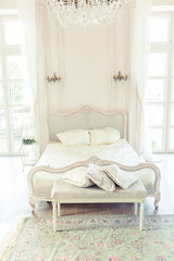 beautiful white bright clean interior bedroom in luxurious baroque style.