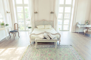 beautiful white bright clean interior bedroom in luxurious baroque style.