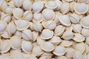 Small frozen dumplings background. Prepared food in the freezer in the store.