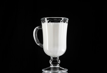 Irish glass with milk on black background .Anti-alcohol concept.Drink milk-be healthy