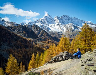 Panoramic landscape of trekker relaxing on the mountains. Gran Paradiso 

National Park. Italy