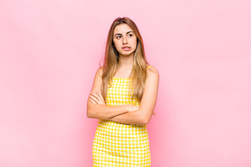 blonde woman doubting or thinking, biting lip and feeling insecure and nervous, looking to copy...