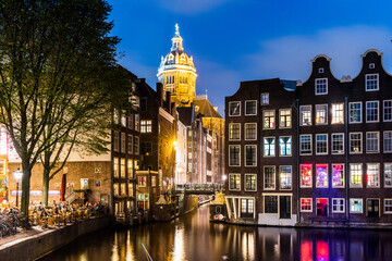 Amsterdam. Night view of Amsterdam cityscape with canal, bridge and typical Dutch Houses.