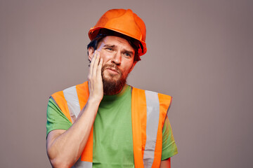 Man in orange paint construction security professional gray background