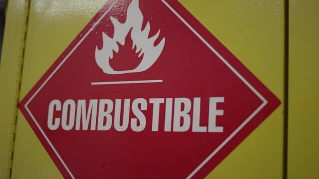 Combustible chemical warning sign on lab supply closet door