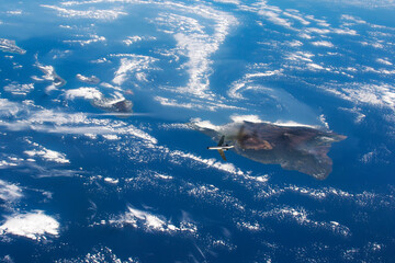 top view of earth surface from space, satellite photo with flying airplane. elements of this image...