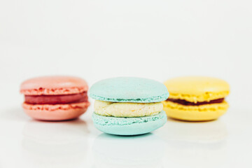 Sweet almond colorful pastel pink blue yellow macaron or macaroon dessert cake isolated on white background. French sweet cookie. Minimal food bakery concept Copy space