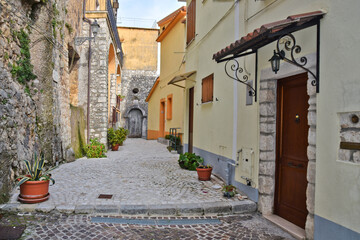 Fototapeta na wymiar A narrow street among the old houses of Ciorlano, an old town in Caserta province, Italy.