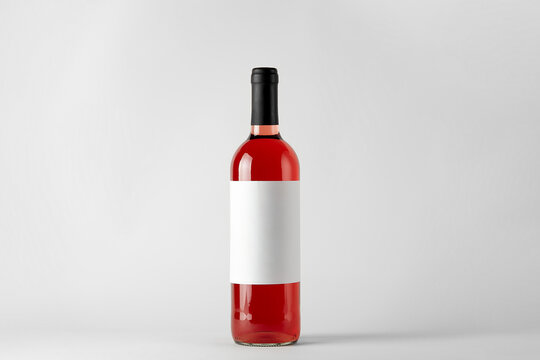 Red Wine Bottle With Rose Wine Isolated On White