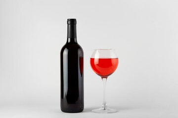 Black wine bottle with red wine isolated on white