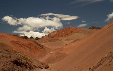 Fototapeta na wymiar High in the Andes cordillera. View of the arid desert, sand, dunes, v shape valley, brown, red and orange mountains and rock formation in Laguna Brava, La Rioja, Argentina. 