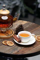 Christmas tea with xmas tree on background. Cup of tea and kettle