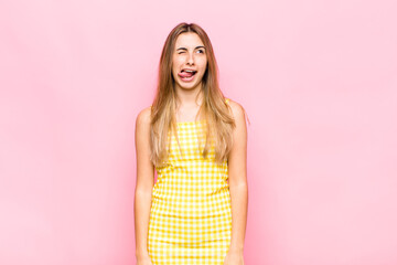 blonde woman looking goofy and funny with a silly cross-eyed expression, joking and fooling around
