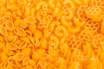 Different pasta types in a heap on the table. Top view