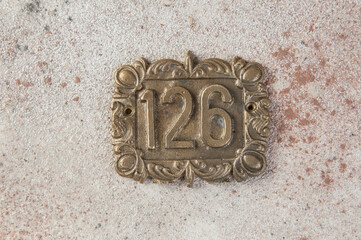 Old brass home number sign