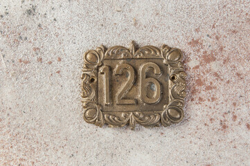 Old brass home number sign