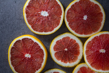 Blood orange on a table. Juicy red fruit texture close up. Gray background with copy space. Healthy...