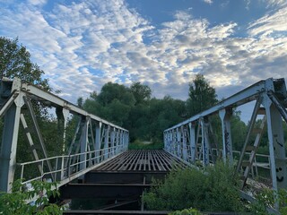 abandoned iron blue bridge on a Sunny summer day