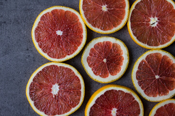 Blood orange on a table. Juicy red fruit texture close up. Gray background with copy space. Healthy...