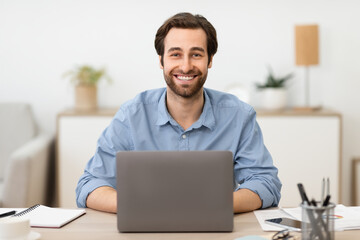 Successful Businessman Sitting At Laptop At Workplace In Modern Office