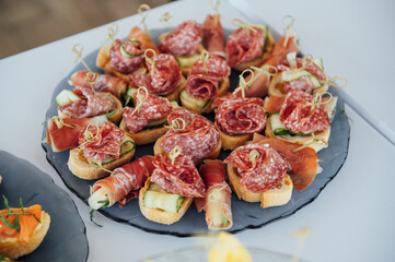 Sandwiches, canapes and cakes on the festive table. A wide variety of snacks