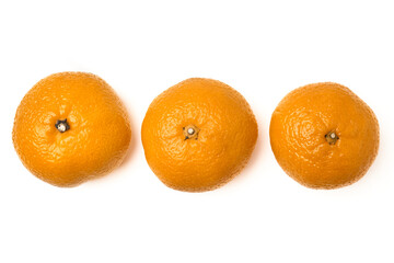 Three juicy tangerines lined up in a row. Isolated on a white background. Holiday mood. Top view.