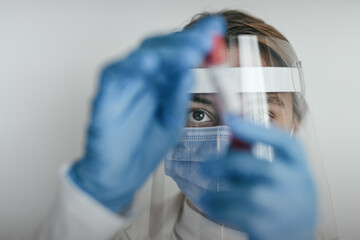 Female doctor wearing protective equipment working - closeup up eye - coronavirus health concept