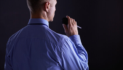 Businessman speech concept, talking with microphone in conference hall