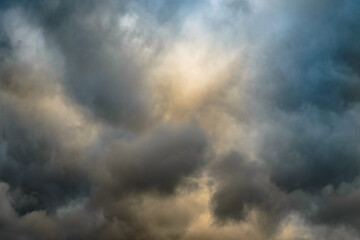 dramatic dark magical sky with cumulus clouds and orange backlighting. artistic image for moody...