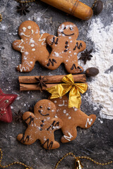 Obraz na płótnie Canvas christmas decorative cookies around grey background. flat lay. christmas background concept