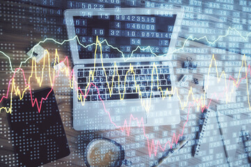 Double exposure of financial chart drawing over table background with computer. Concept of research and analysis. Top view.