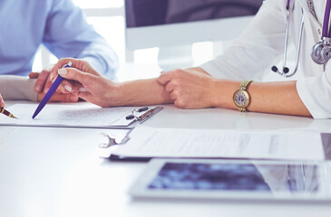 Portrait of senior doctor in office sitting at the desk